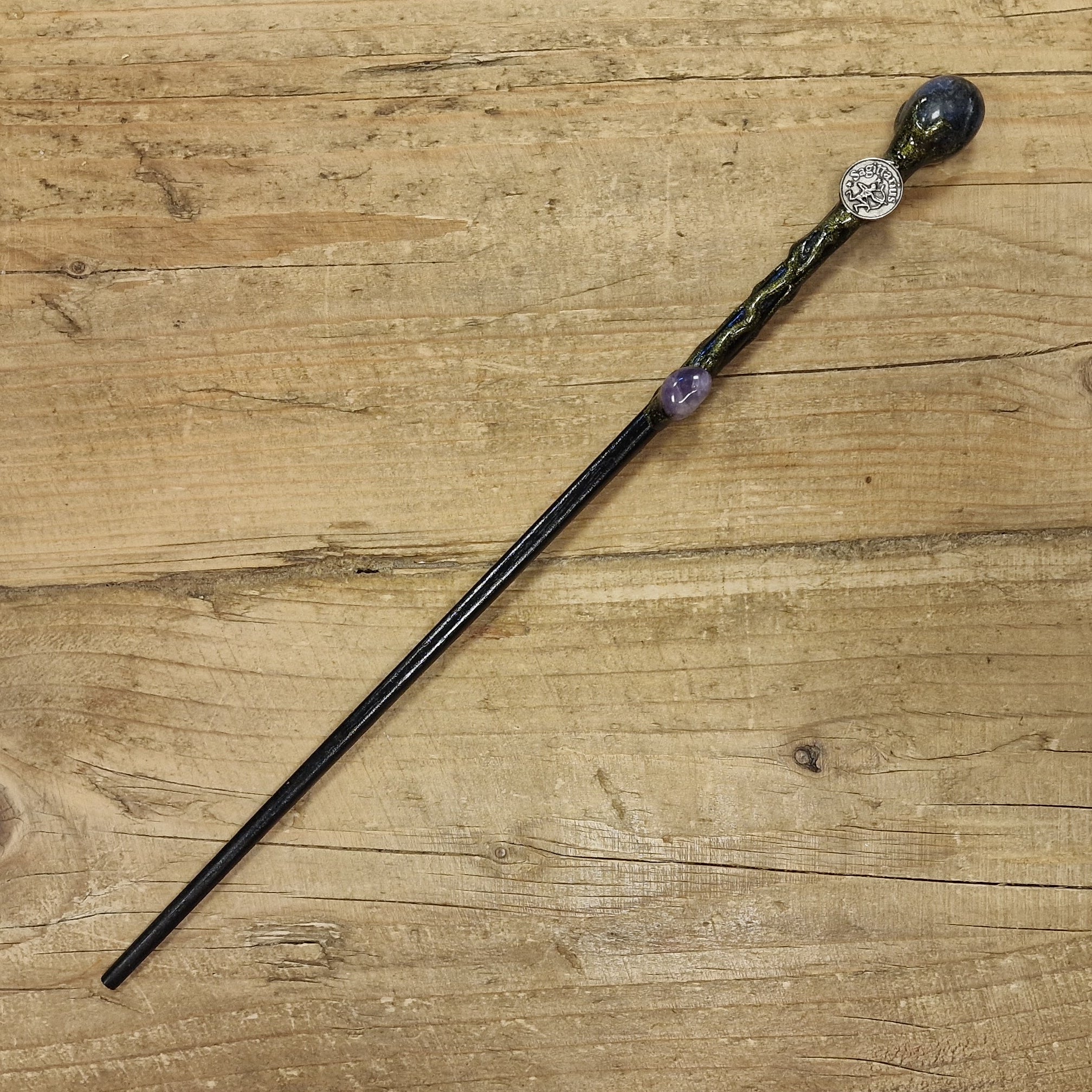 black wooden magic wand with Sagittarius symbol