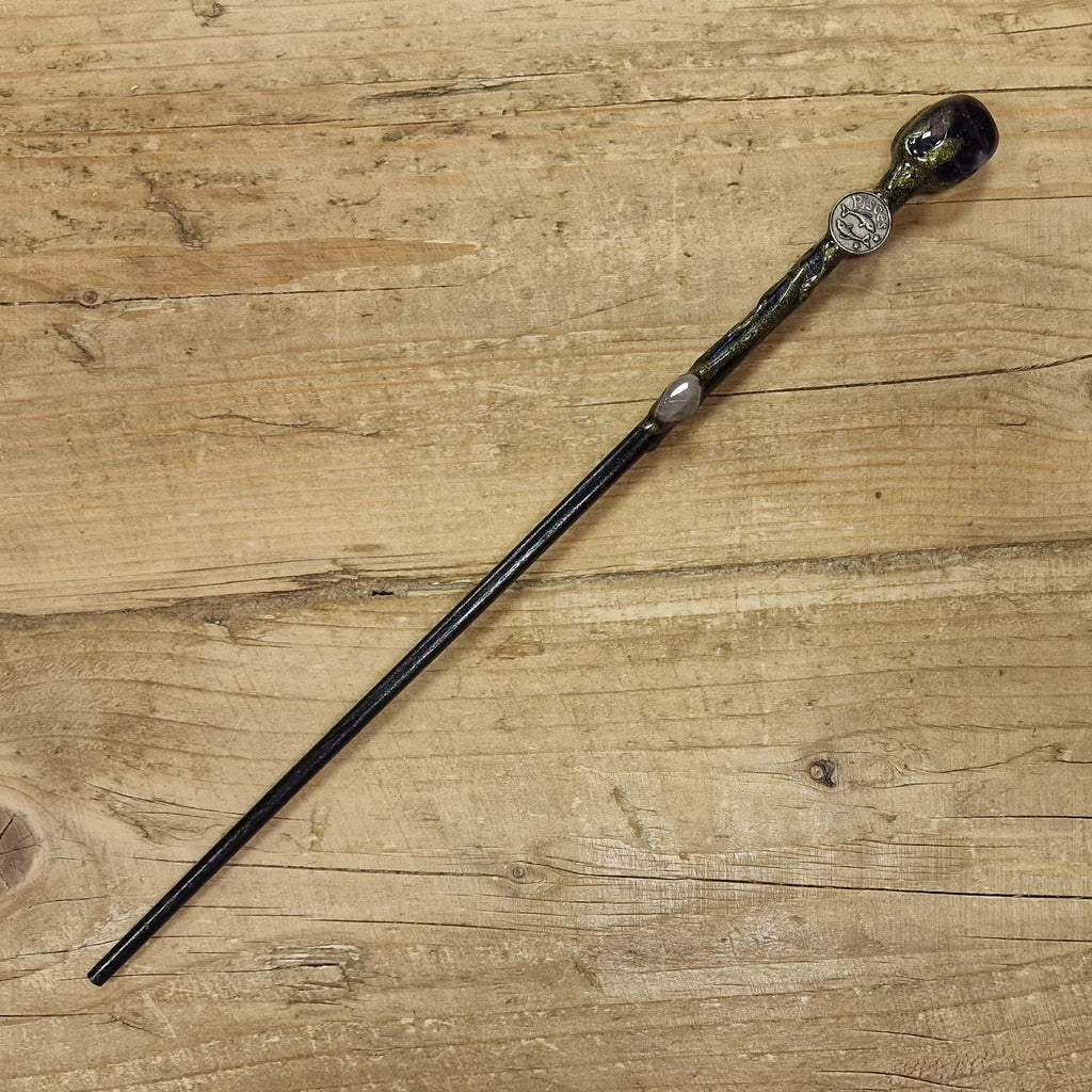 black wooden magic wand with pisces symbol 