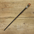 black wooden magic wand with aries symbol