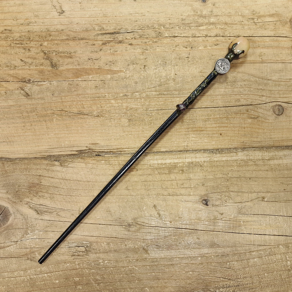 Black wooden magic wand with virgo symbol