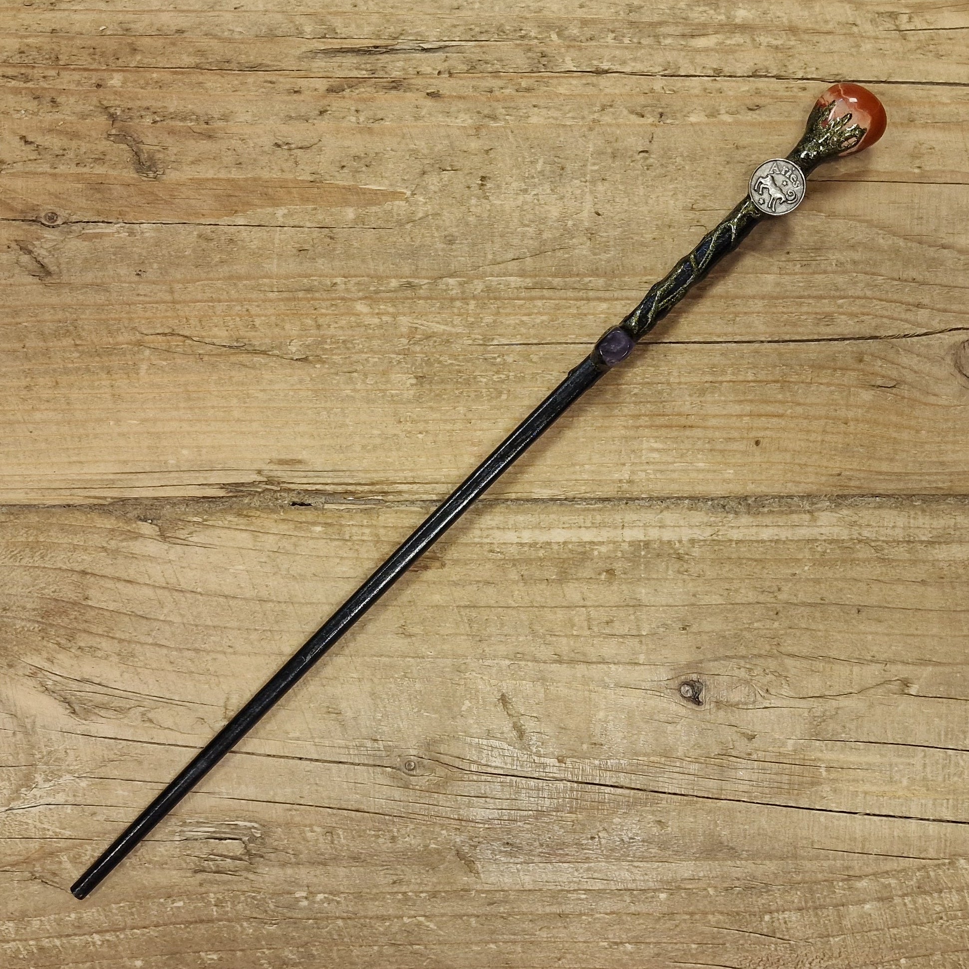 Black wooden magic wand with aries sign