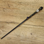 black wooden magic wand with Capricorn symbol