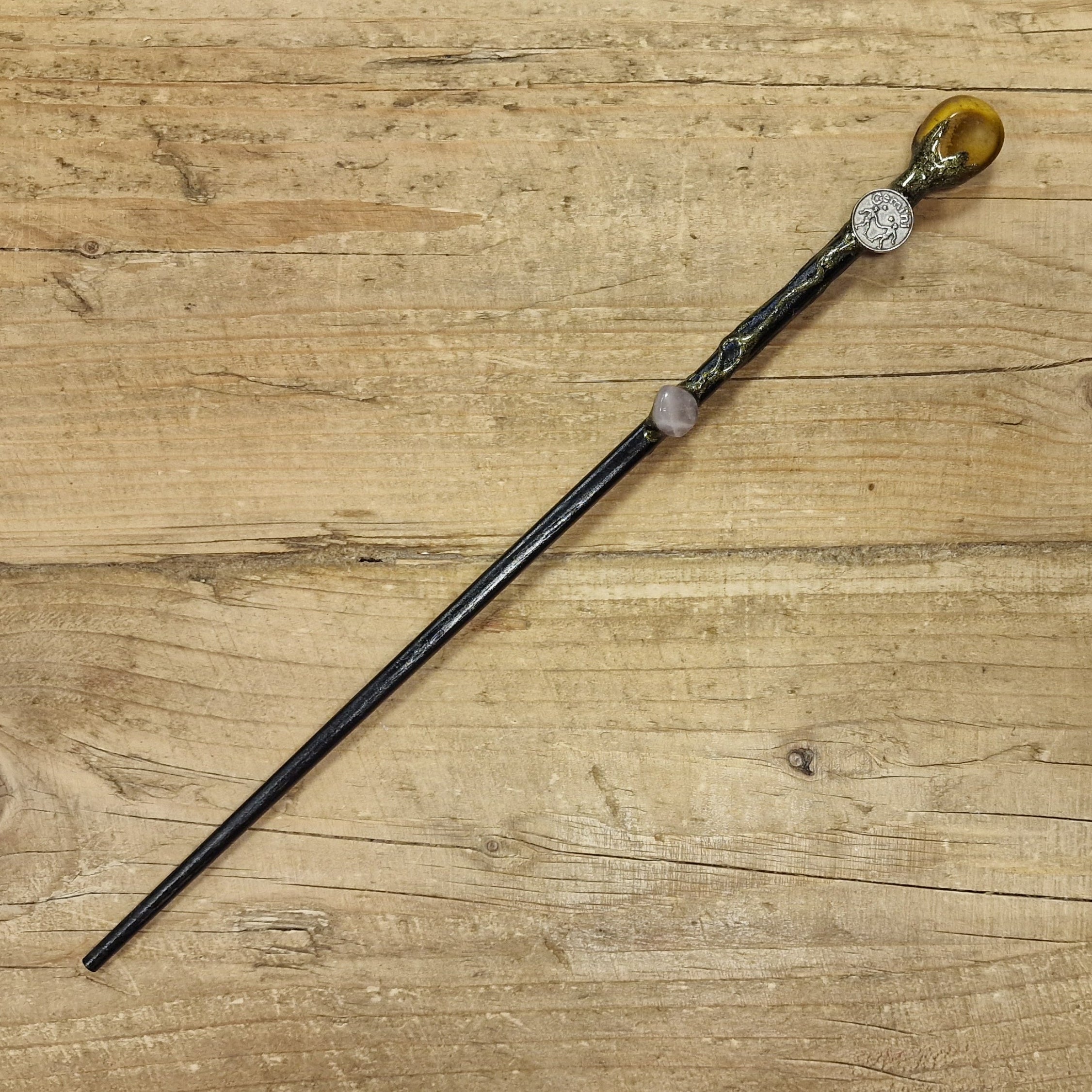 Black wooden magic wand with gemini symbol