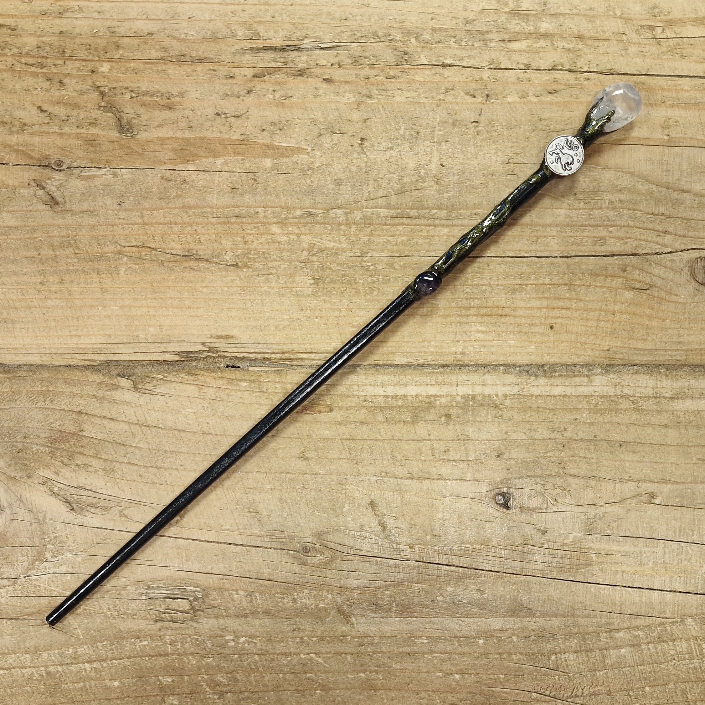 black wooden magic wand with leo symbol