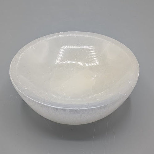 Large selenite bowl on a gray background