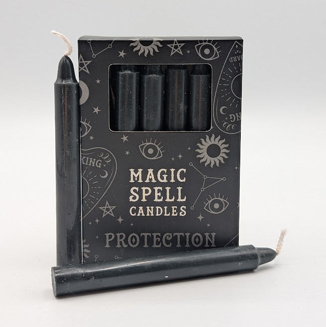 Set of black candles with packaging labeled 'Magic Spell Candles Protection' on a white background