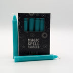 Teal candles with packaging labeled 'Magic Spell Candles Luck' on a white background