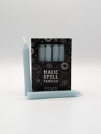 Set of light blue candles with a black packaging label on a white background