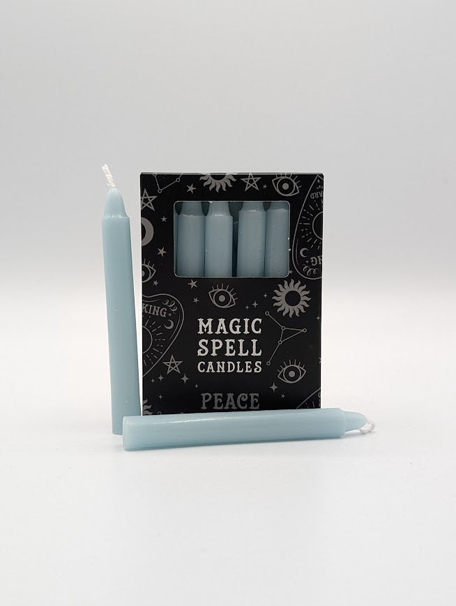 Set of light blue candles with a black packaging label on a white background