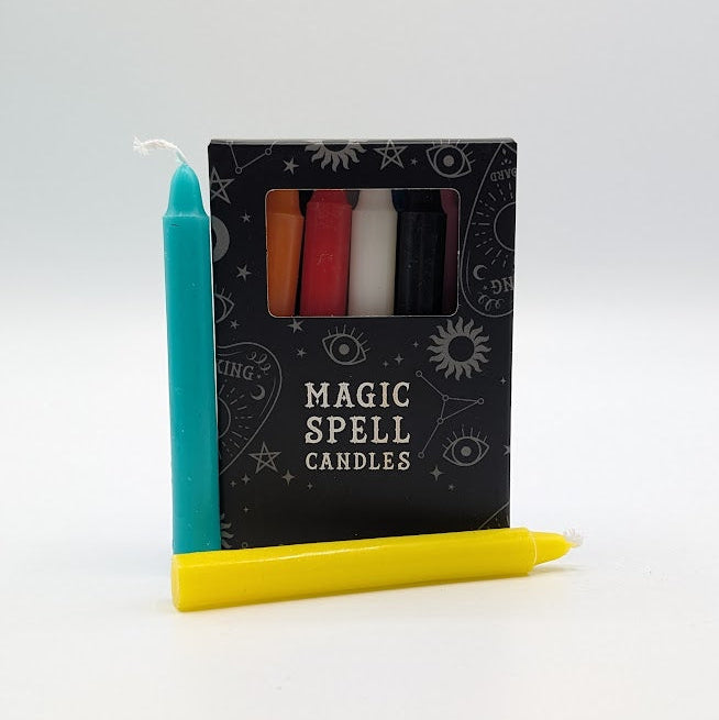 Set of various candles with a 'Magic Spell Candles' packaging on a white background