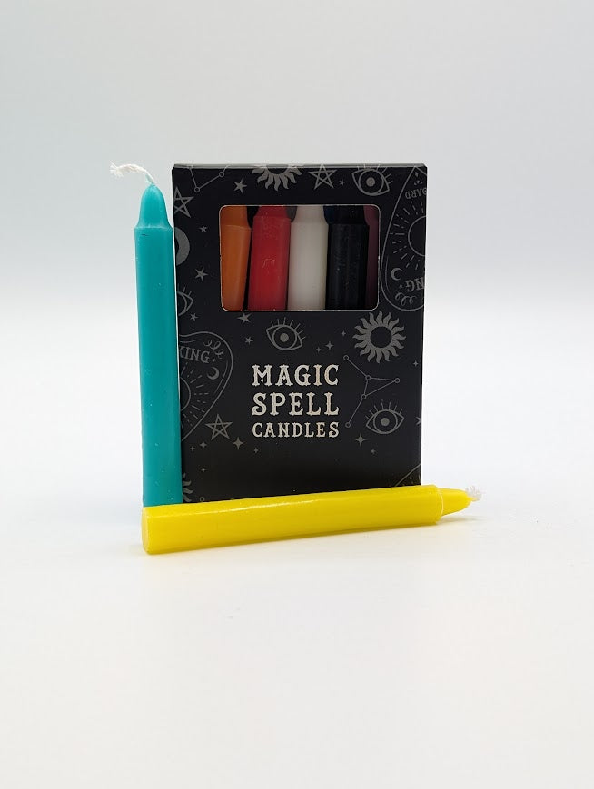 Set of various candles with a 'Magic Spell Candles' packaging on a white background