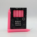 Pink candles with a 'Magic Spell Candles Friendship' packaging on a gray background