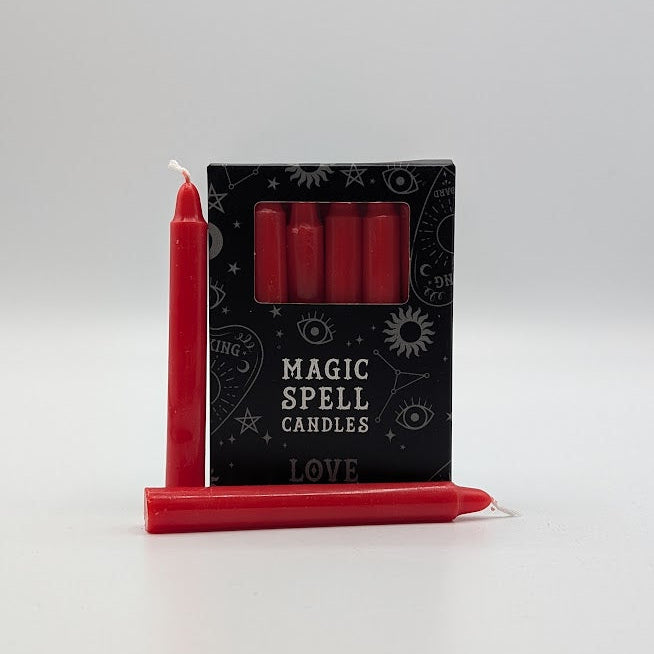 Red spell candles with packaging labeled 'Magic Spell Candles' on a white background