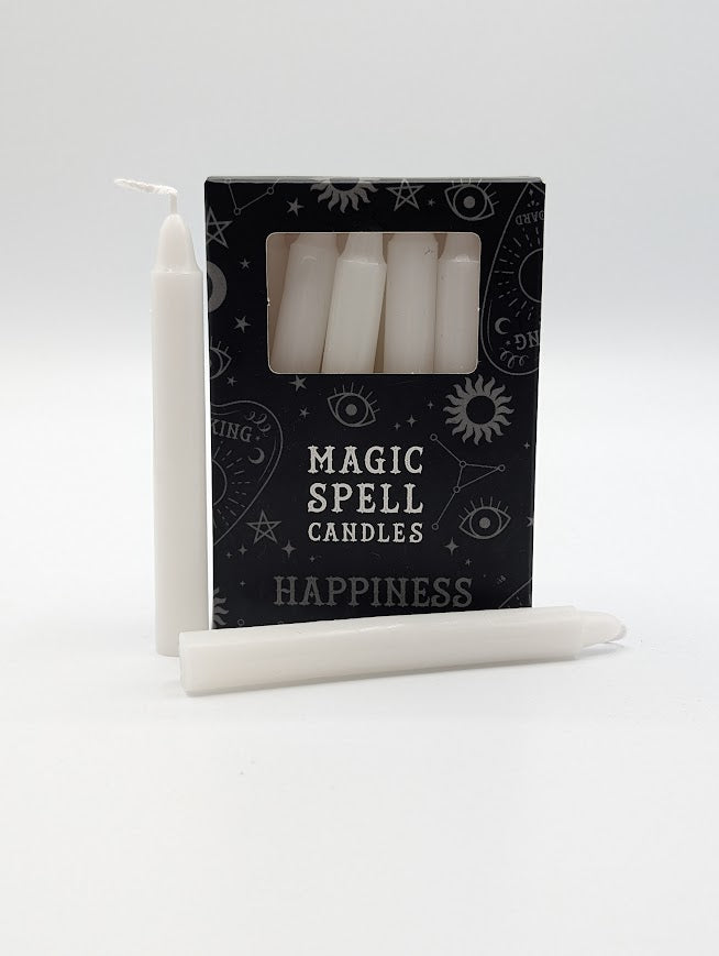 White candles with a black box labeled 'Magic Spell Candles Happiness' on a white background