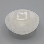 Medium sized selenite bowl on a grey background