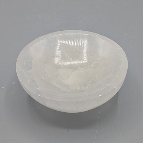 Medium sized selenite bowl on a grey background