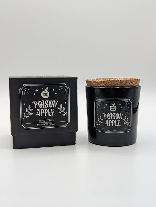Candle labeled 'Poison Apple' sweet apple scented with packaging on a light gray background