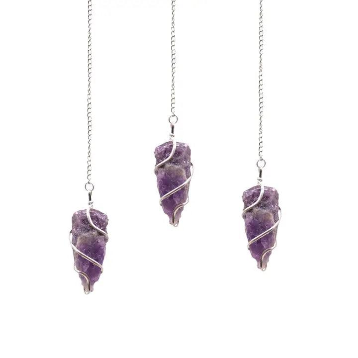 Three purple amethyst stone pendulums on silver chains against a white background