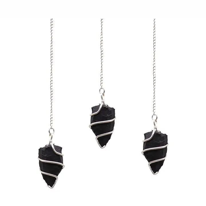 Three black stone pendulums on silver chains on a white background