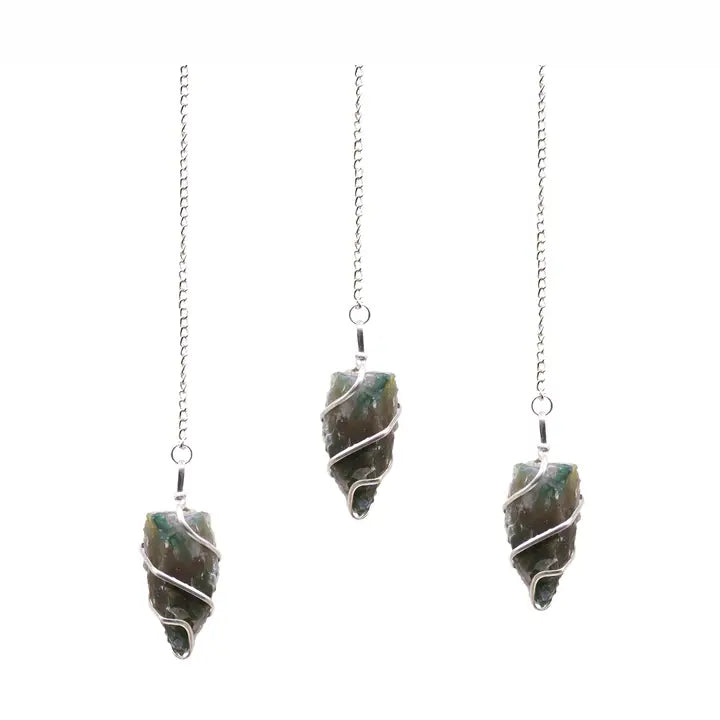 Three green stone pendulums on silver chains against a white background