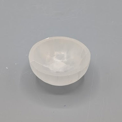 Small selenite bowl on a grey background