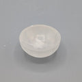 Small selenite bowl on a grey background