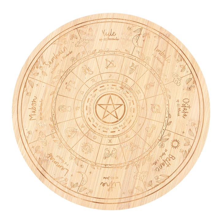 Wooden cutting board with engraved pagan wheel of the year and astrological design on a white background
